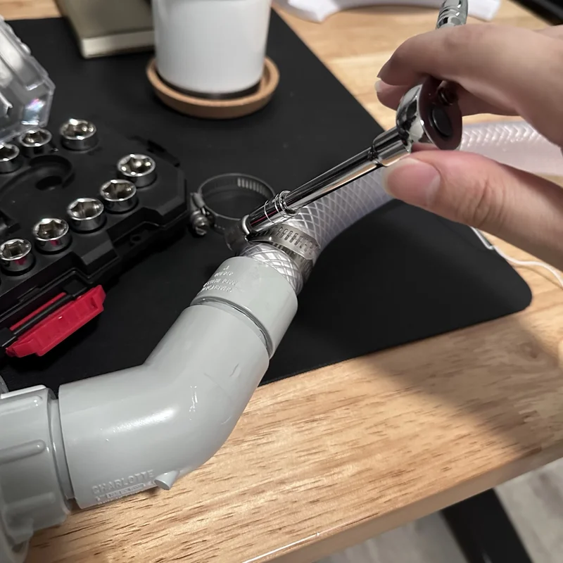 soft vinyl tubing being ratcheted tight with a clamp
